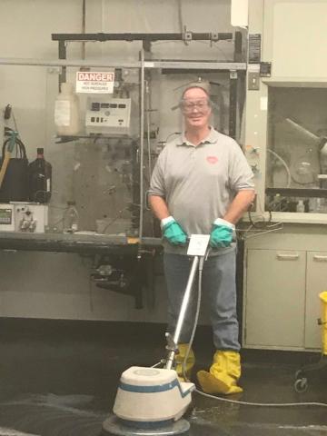 Staff person using floor machine